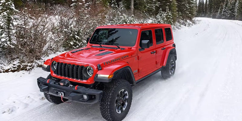 Red Jeep Wrangler snow drive