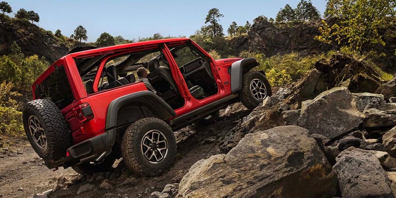 Red Jeep Wrangler rock crawling